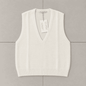 gilet in maglia crema su piastrelle neutre